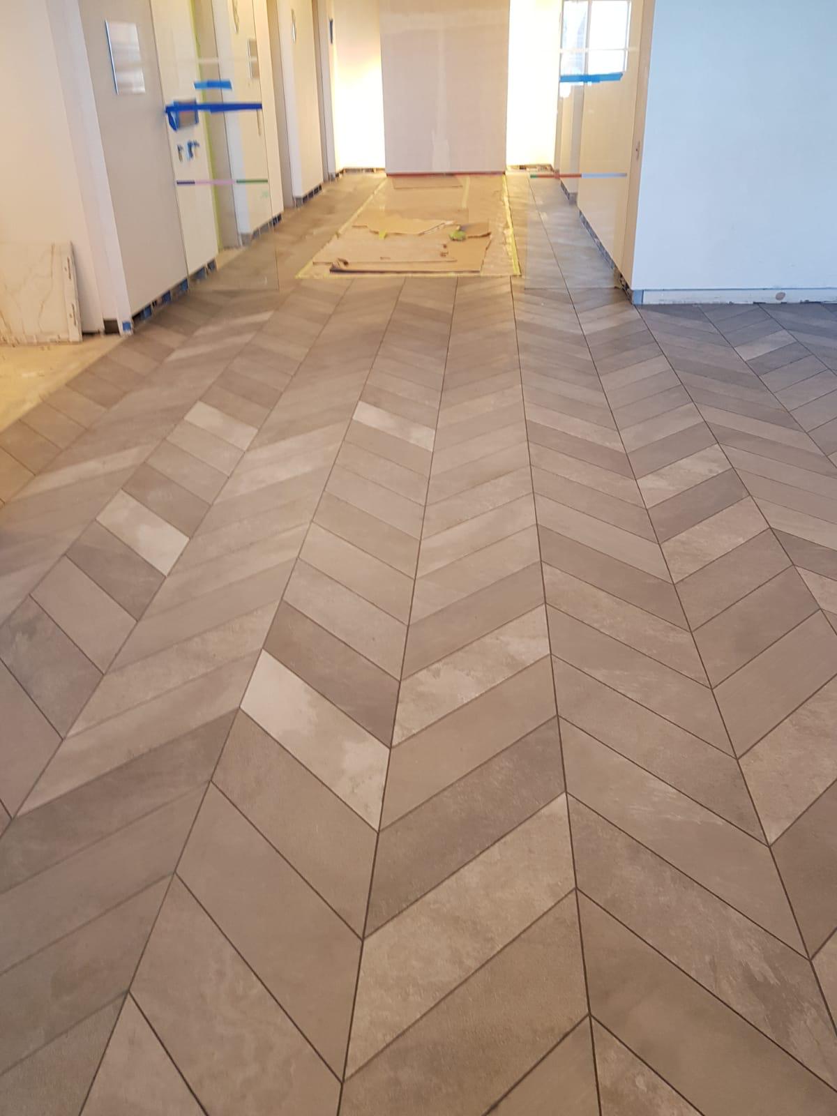 Chevron floor tile installation in private interior