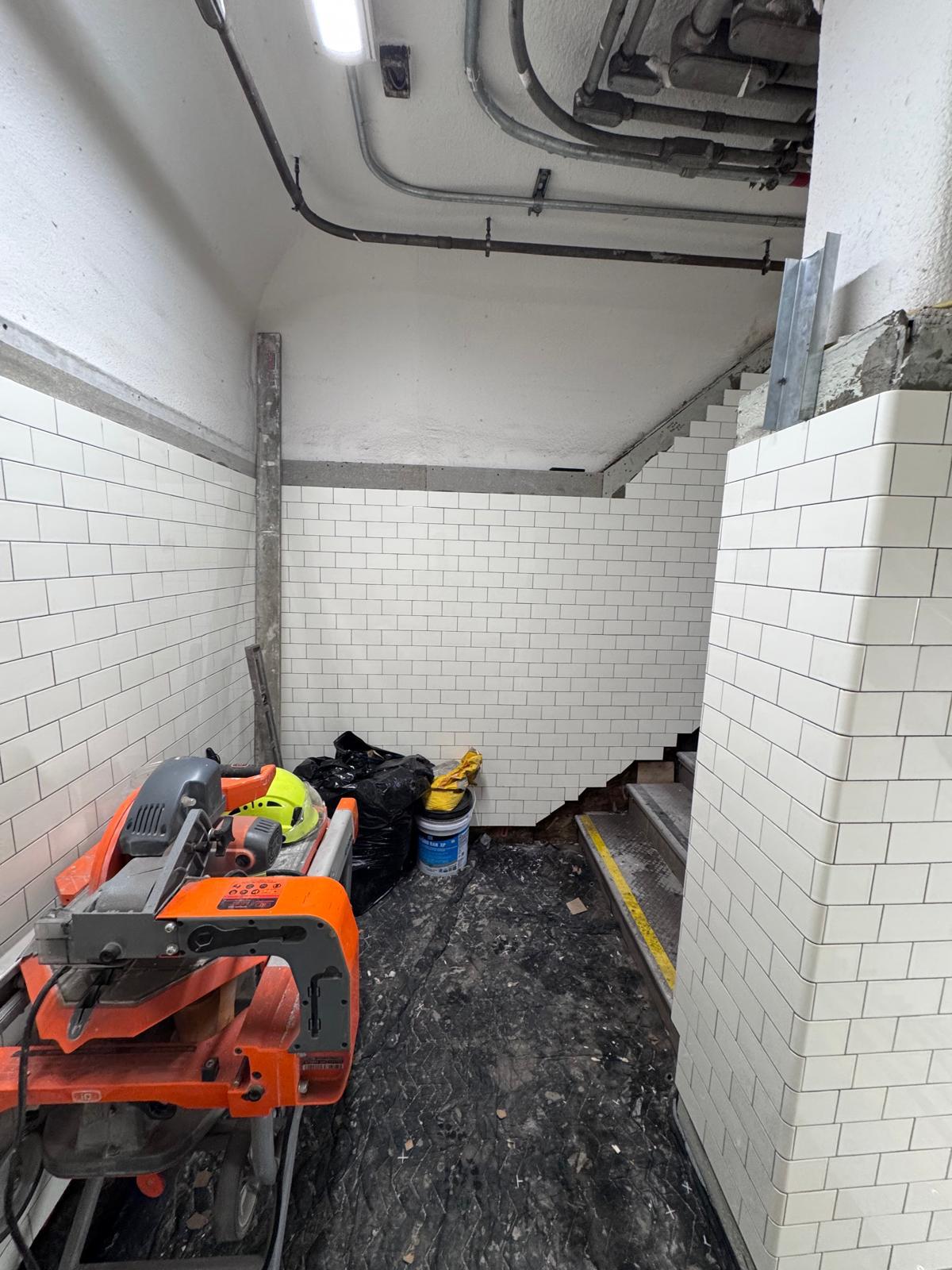 Newport PATH Station stair landing wall tile