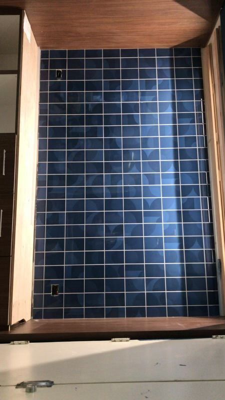 Blue hospitality tile wall installation by MJ Stone and Tile