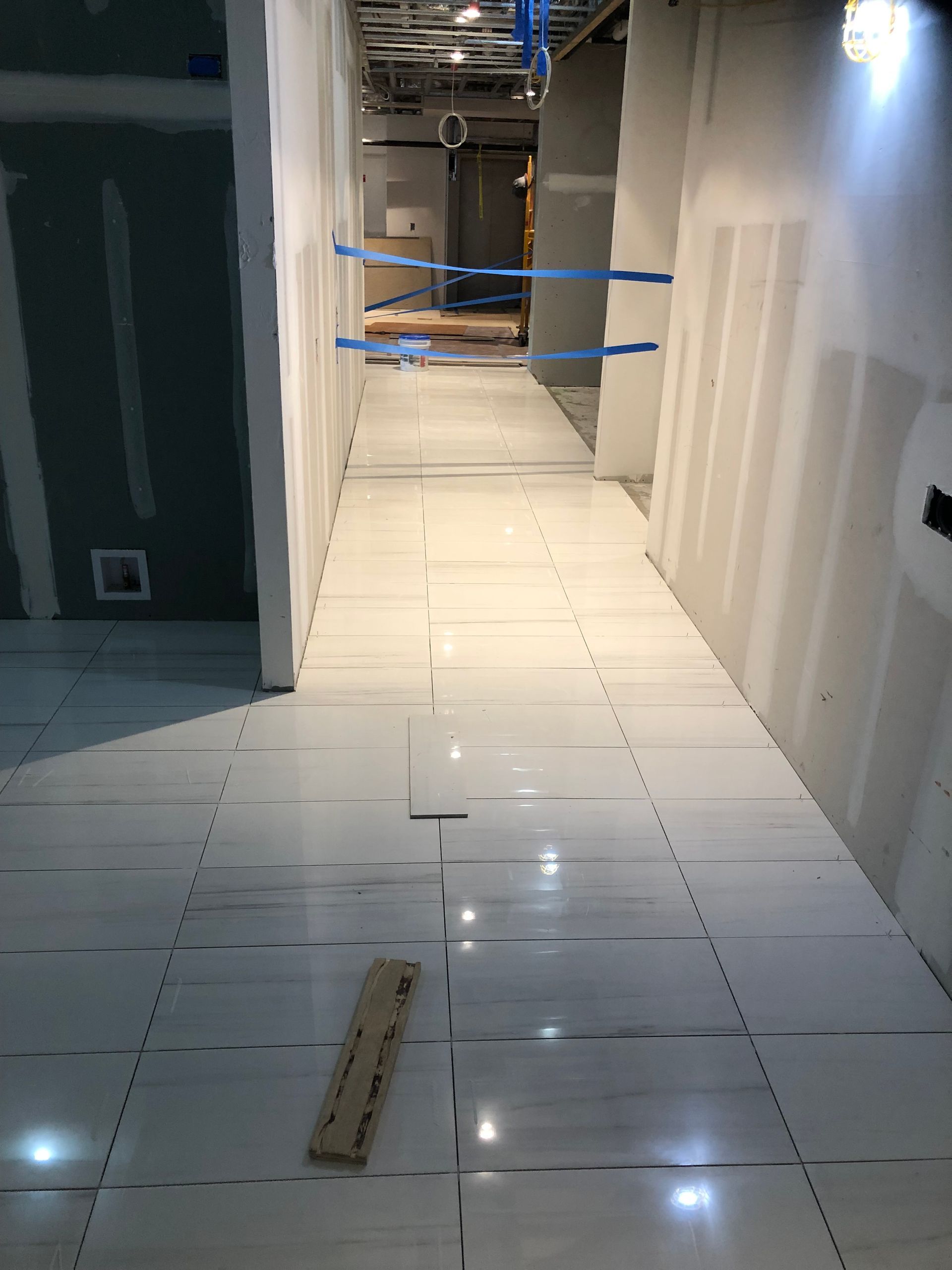 Long commercial hallway with tile floor installation